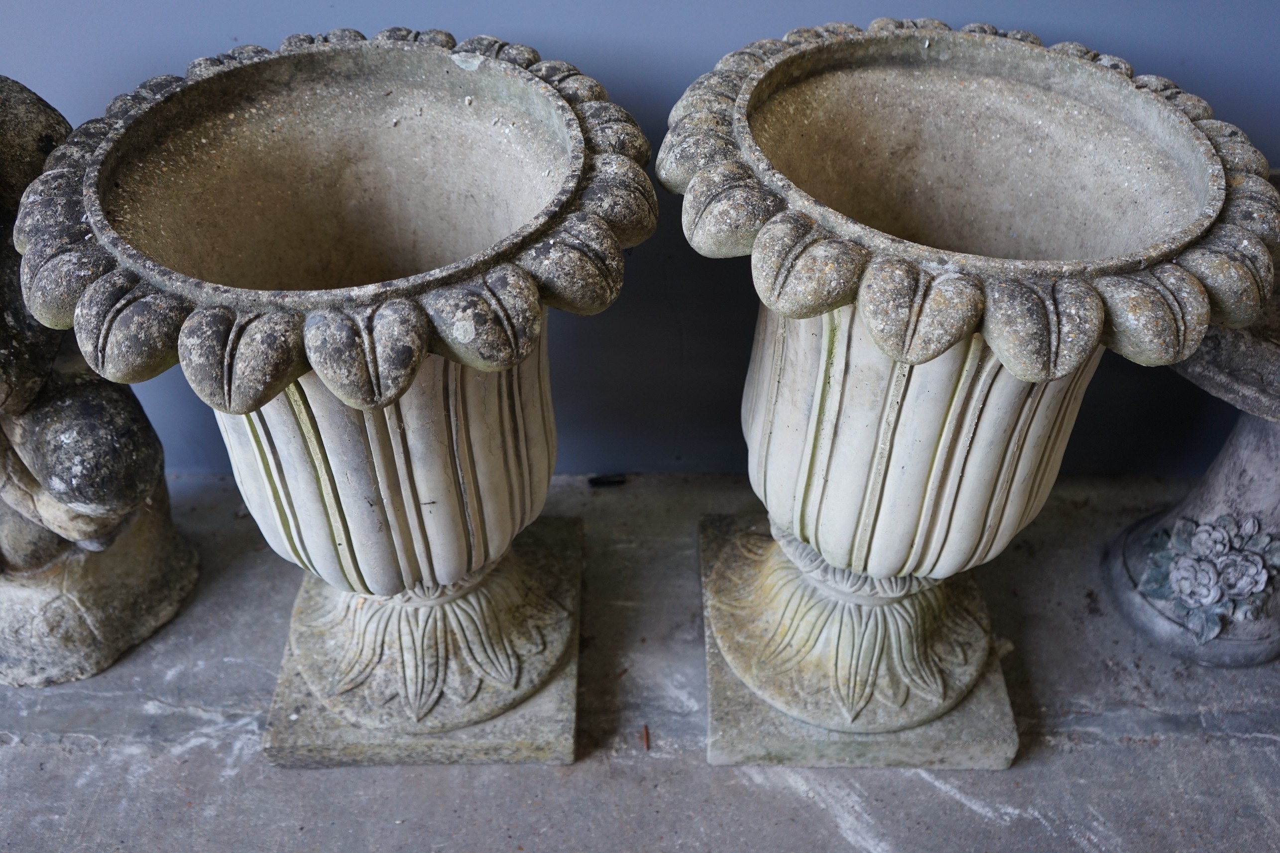 A pair of reconstituted stone campana garden urns, diameter 50cm, height 67cm